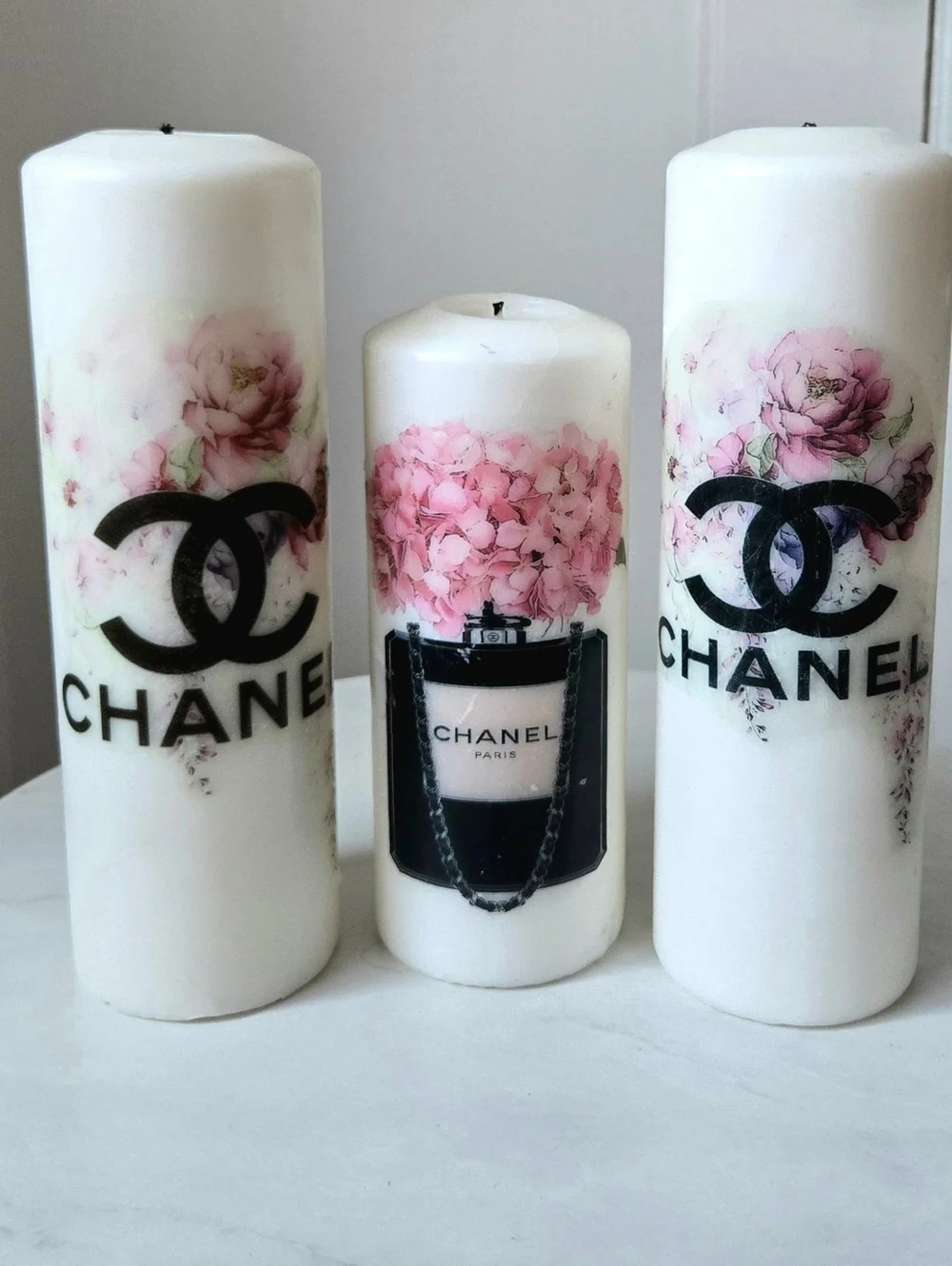 White Pillar Candles with Pink Floral Motif and Black Logo